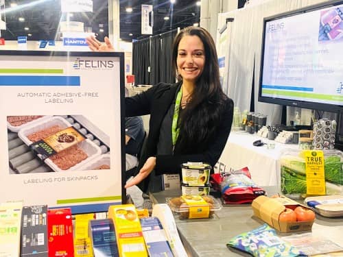 IPPE 2022 - Felins Booth - Lisa with Material Display for Adhesive Free Labeling