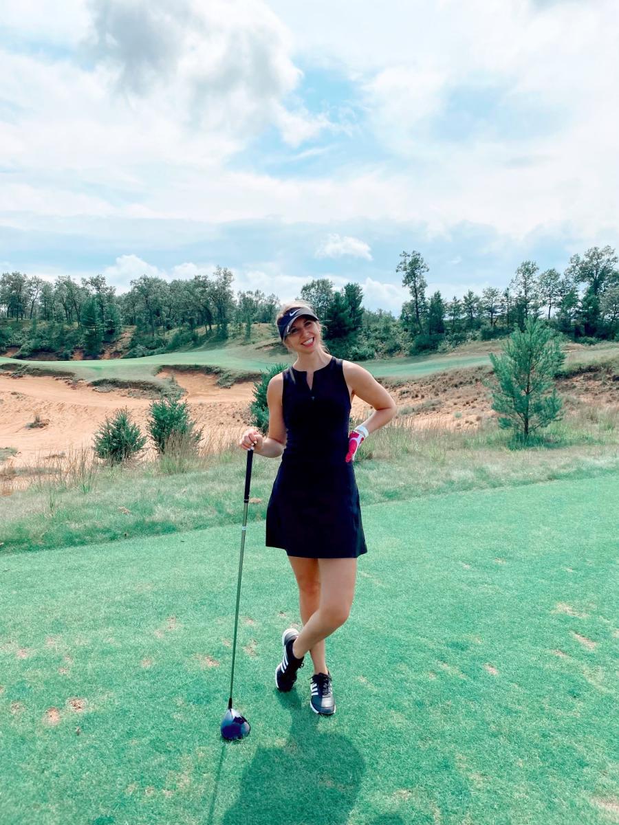 Briana standing on a golf course