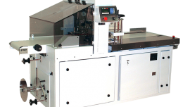 Shrink wrapping machine, automated shrink wrapper, lower profile wrapper, laundry wrapper