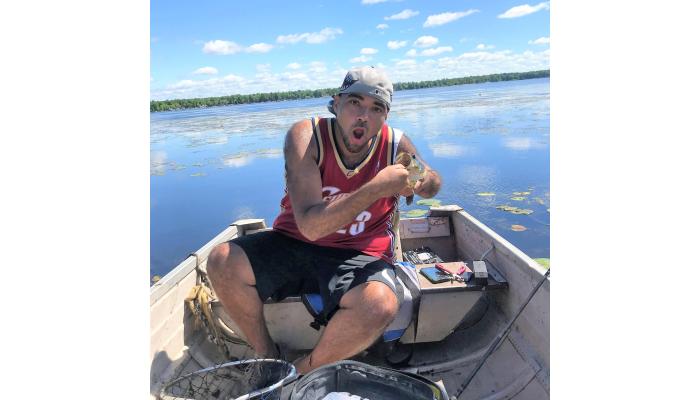 Felins Company Culture - Keiffer poses with a catch during a fishing trip