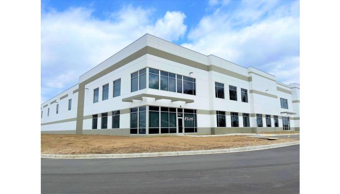 Felins is moving to a new building, the photo shows the new building with large windows and contrasting white exterior walls.